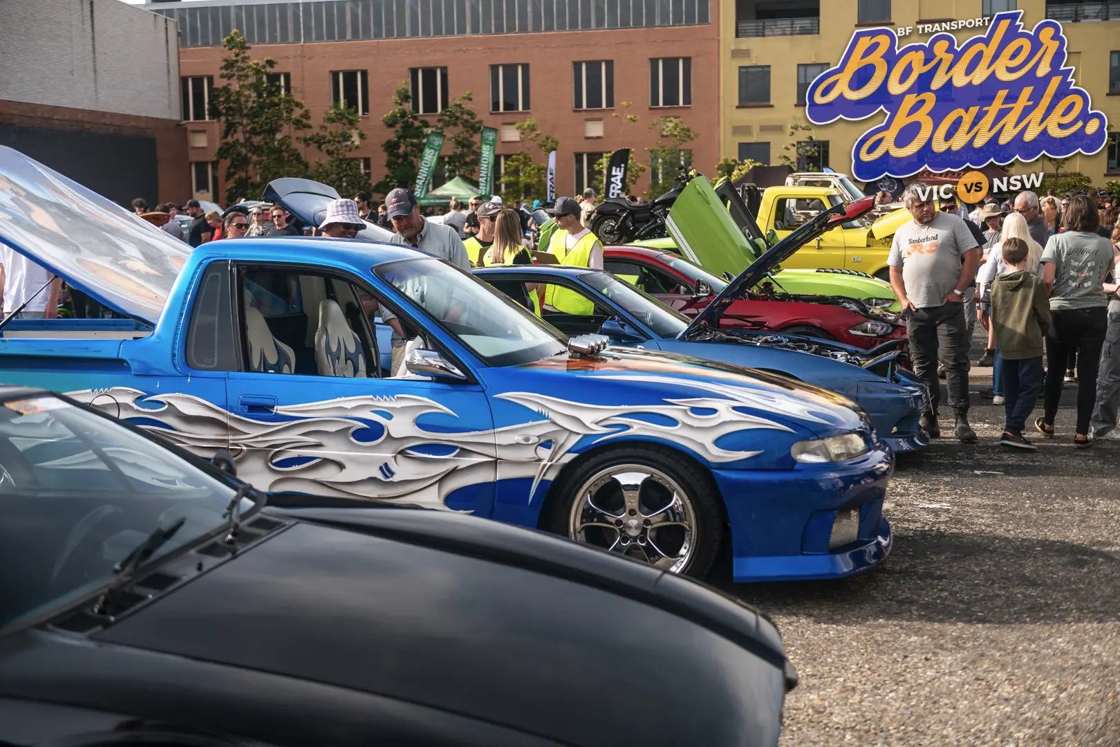 Blue custom ute among a busy crowd at Border Battle