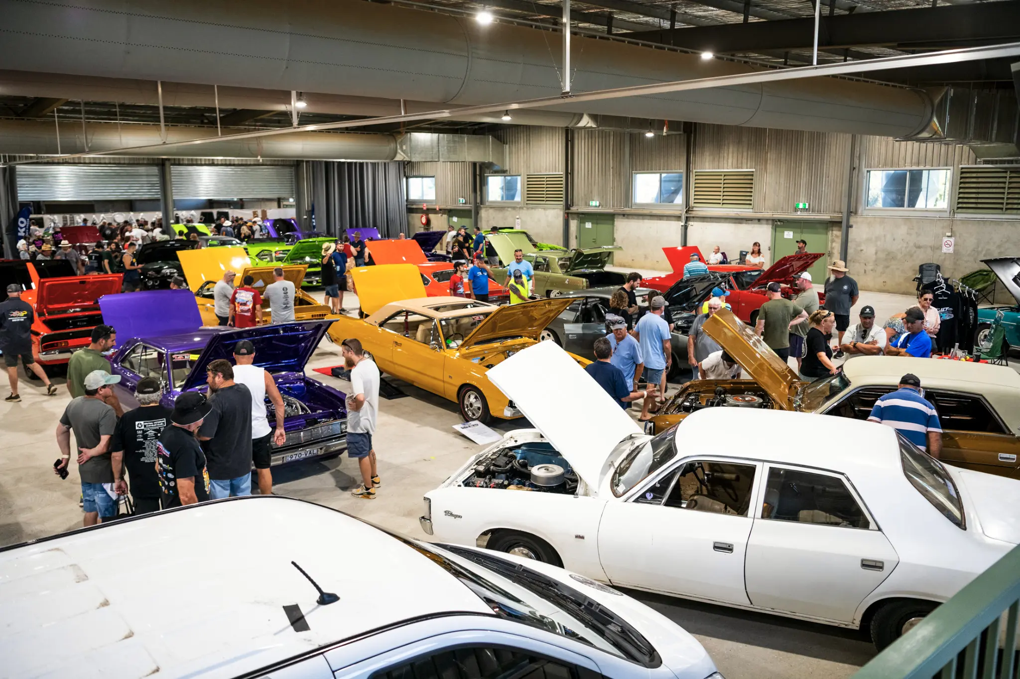 Visitors exploring rows of colourful Chrysler vehicles inside the event pavilion