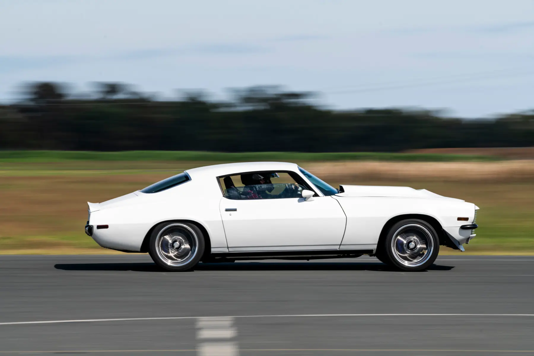 White second-generation Camaro photographed at speed