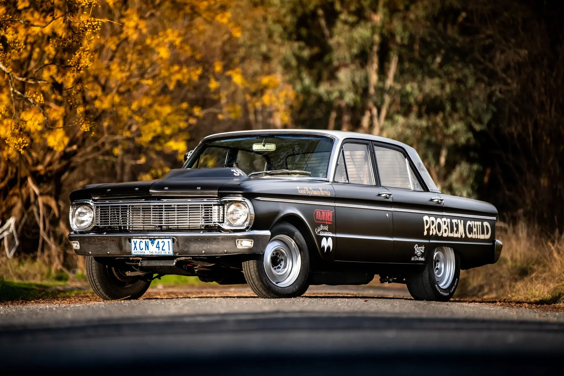 Black drag car photographed on a country road