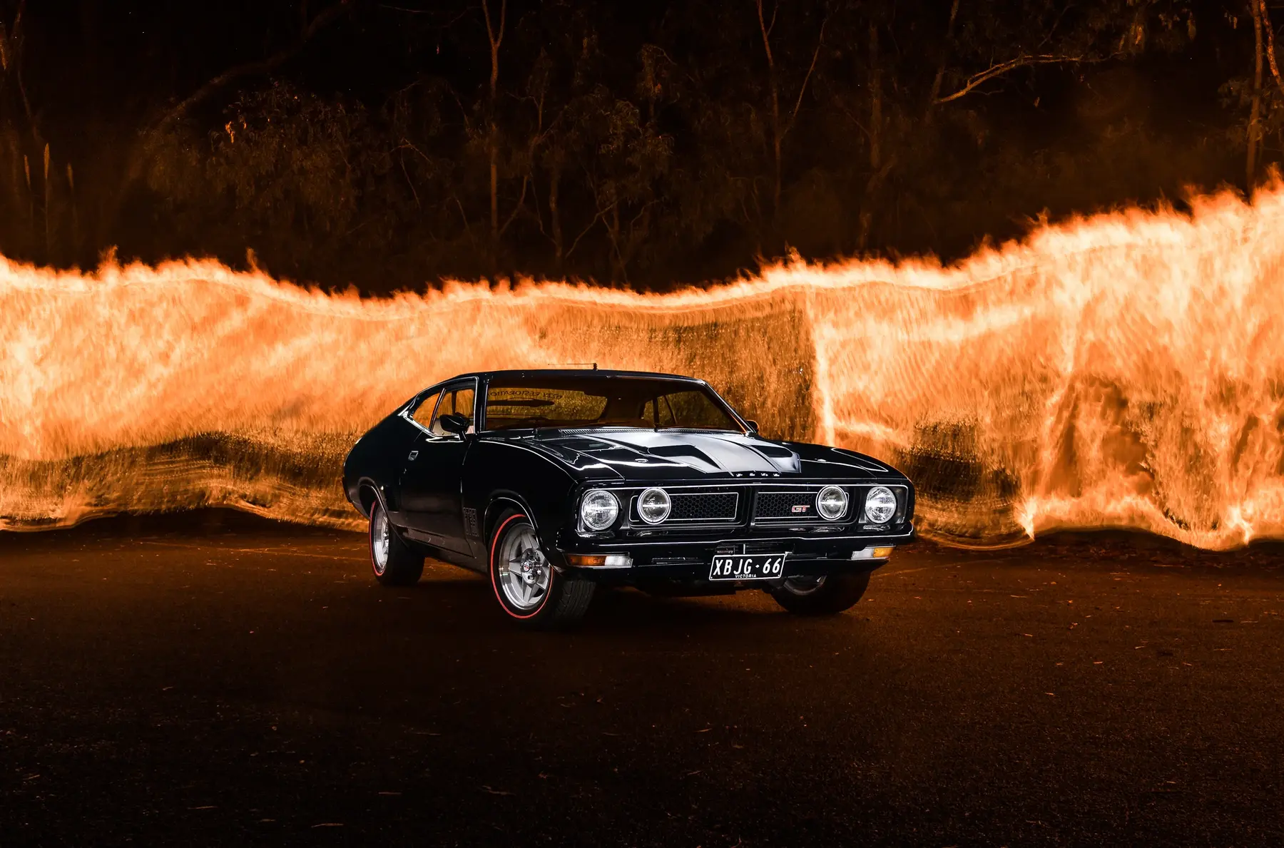 Classic Ford Falcon photographed with a sweeping light trail at night